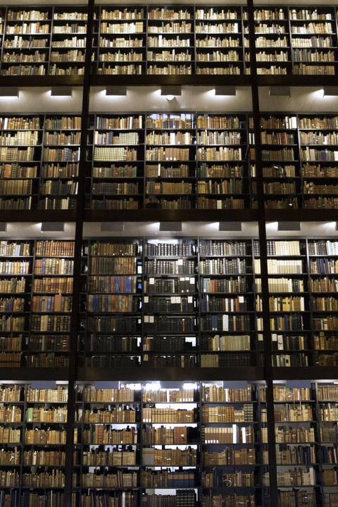 towering shelves of books in Beinecke Library